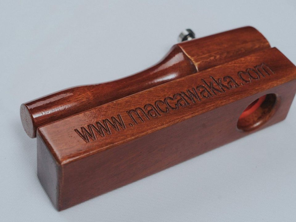 Side view of the MaccaWakka showing the stainless steel strike plate set into the hardwood base